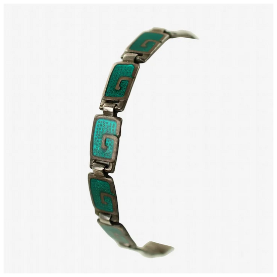 Silver bracelet with turquoise enameled squares on a white background