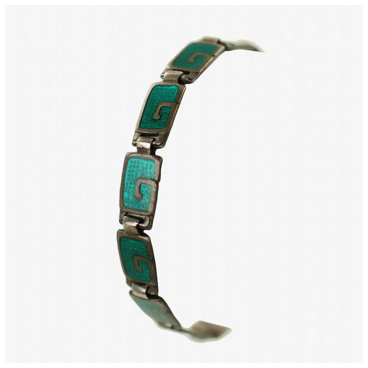 Silver bracelet with turquoise enameled squares on a white background