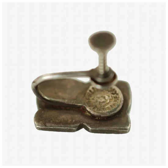 Metallic stamp with a coin on a white background