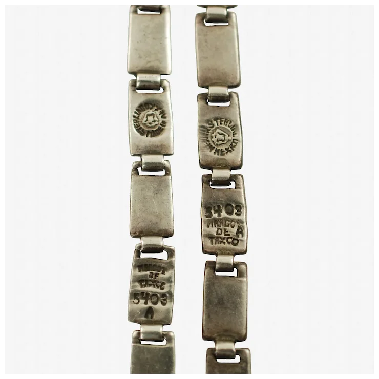 Silver bracelet with engraved text on a white background