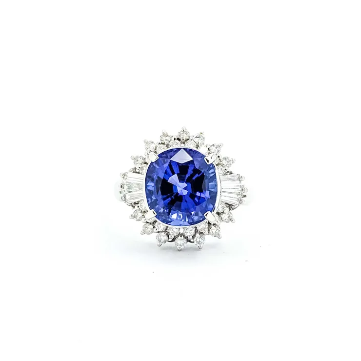 Diamond ring with a blue gemstone on a white background