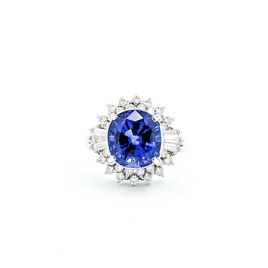 Diamond ring with a blue gemstone on a white background