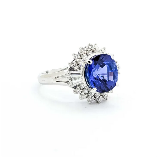 Ring with a blue gemstone and diamond accents on a white background