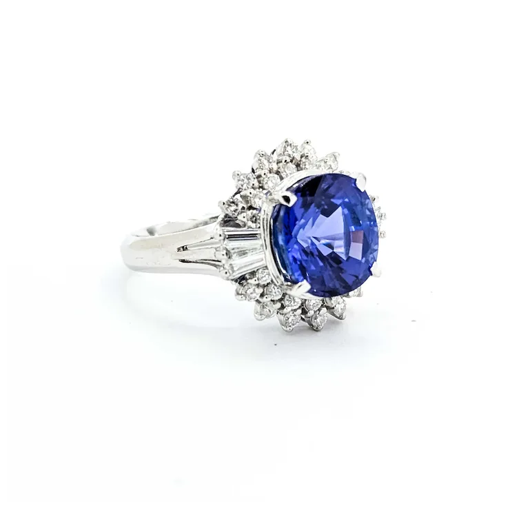 Ring with a blue gemstone and diamond accents on a white background
