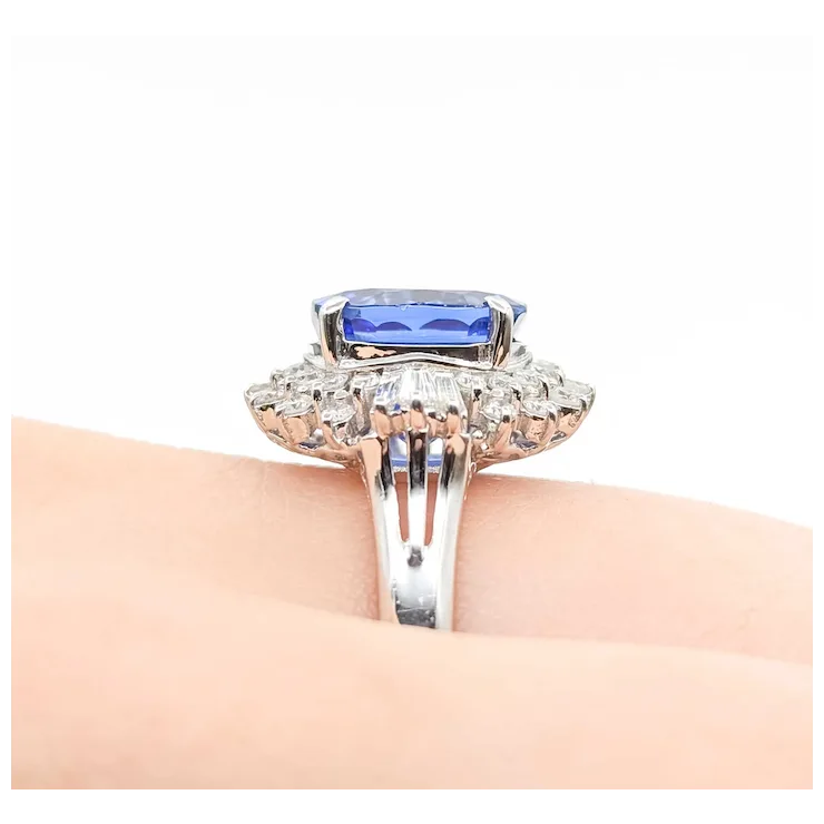 Elegant ring with a blue gemstone and diamond accents on a white background