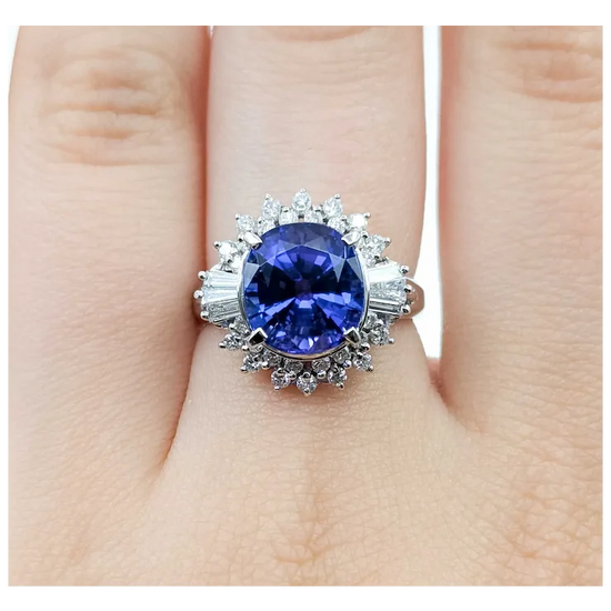 Ring with a blue gemstone on a finger