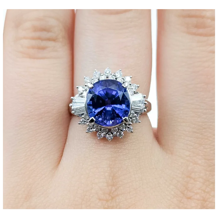 Ring with a blue gemstone on a finger