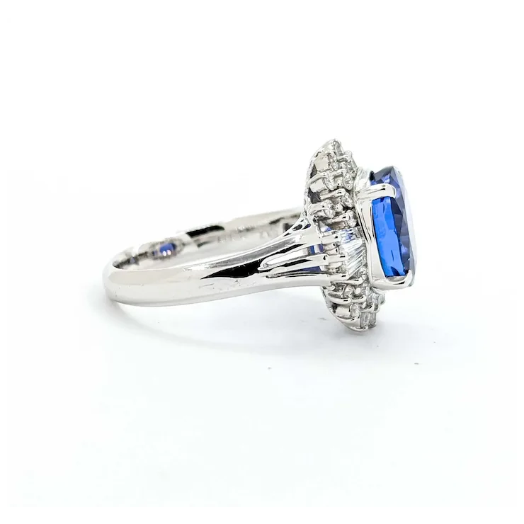 Diamond ring with blue gemstone on a white background