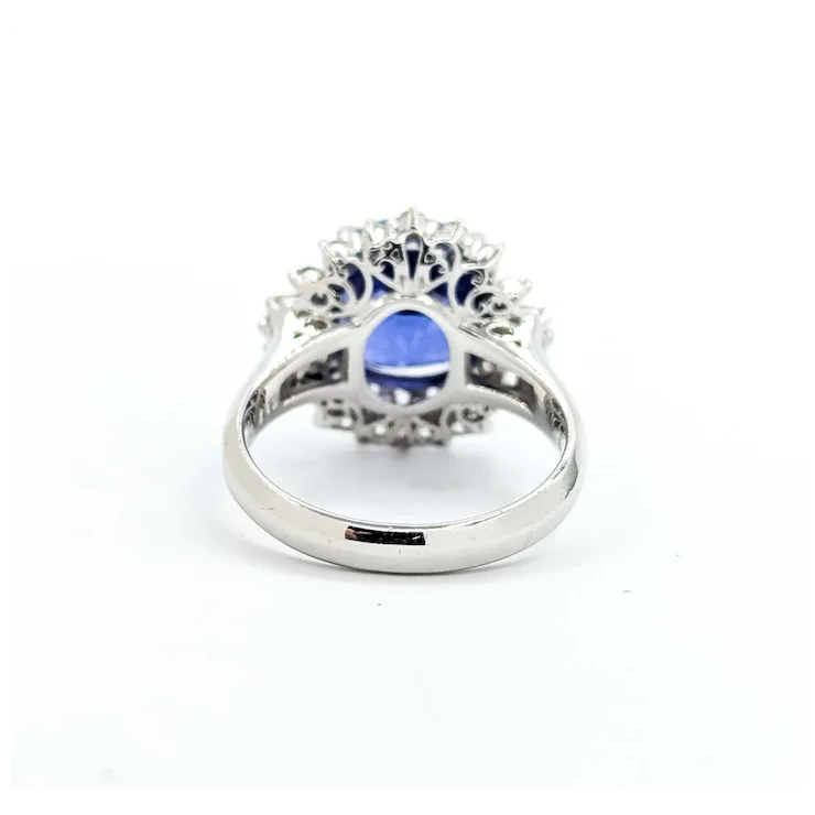 Silver ring with a blue gemstone on a white background