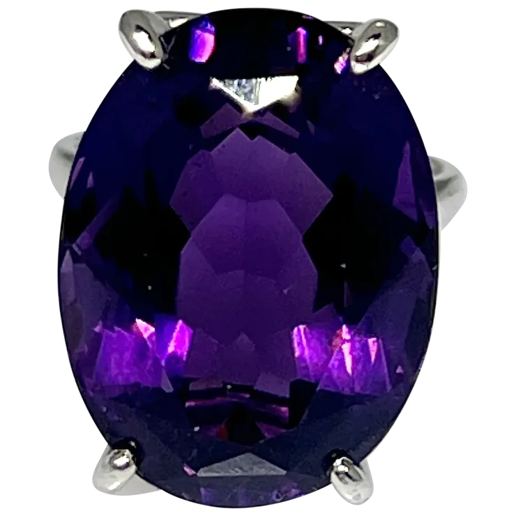 Ring with a large purple gemstone on a white background
