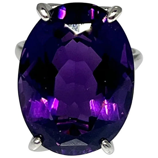Ring with a large purple gemstone on a white background