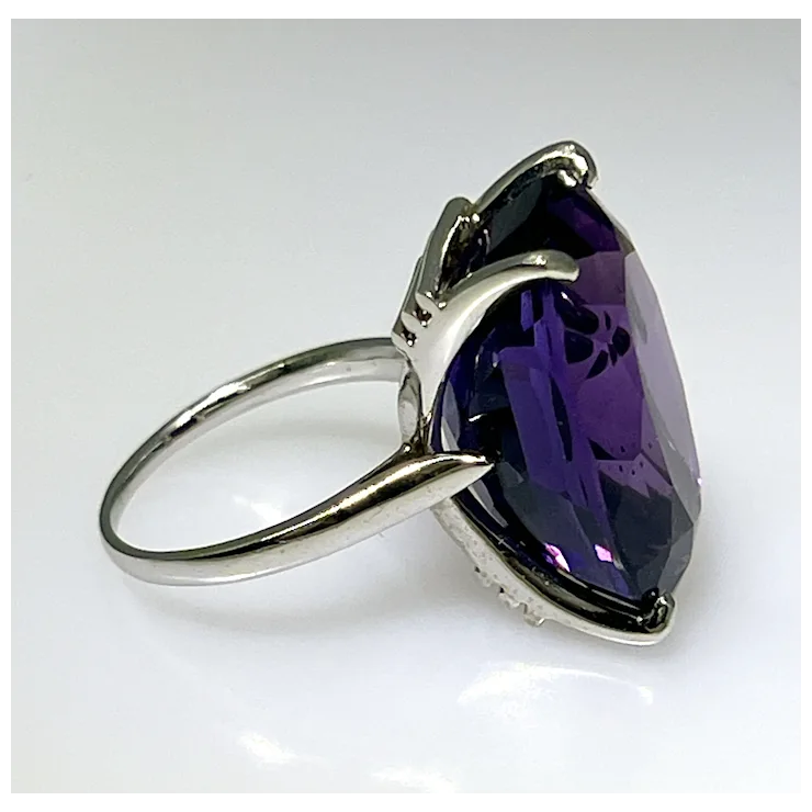 Ring with a large purple gemstone on a white background